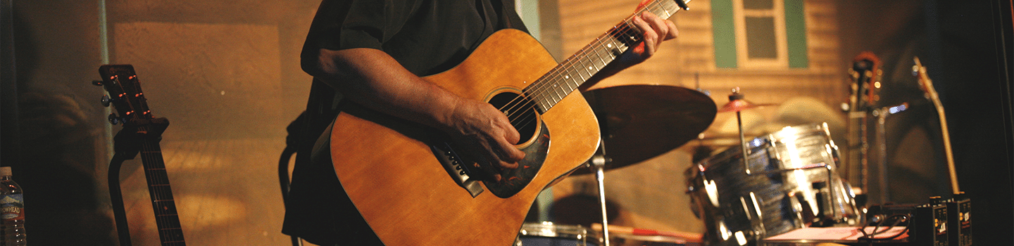 Man holds guitar.