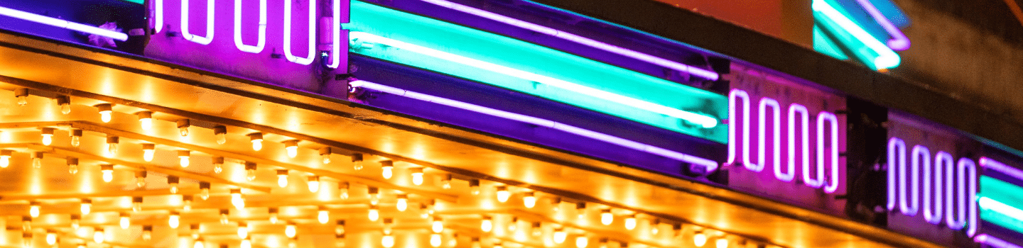 close up of neon lights of marquee sign