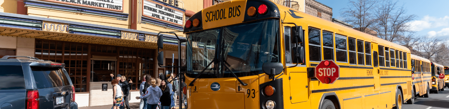 school bus and children outside the tower theatre